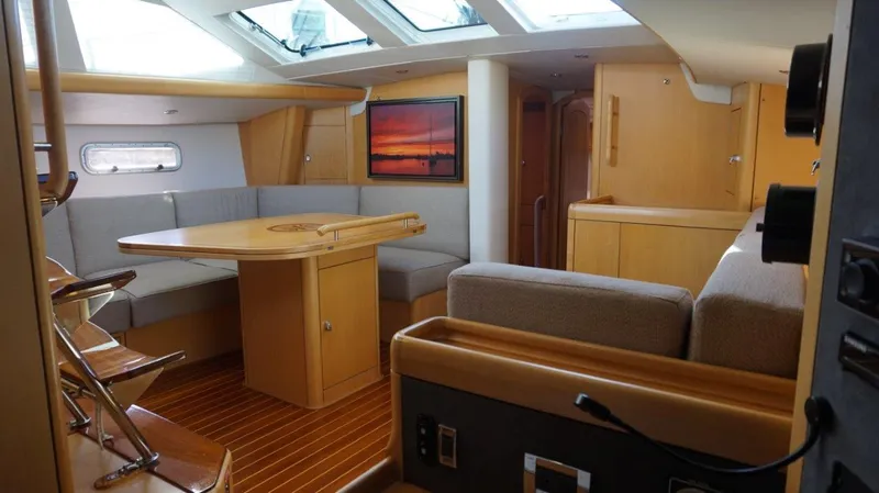 Slide: The Image of Interior of 2008 Oyster 46 yacht with modern wood finish and seating area. - 36