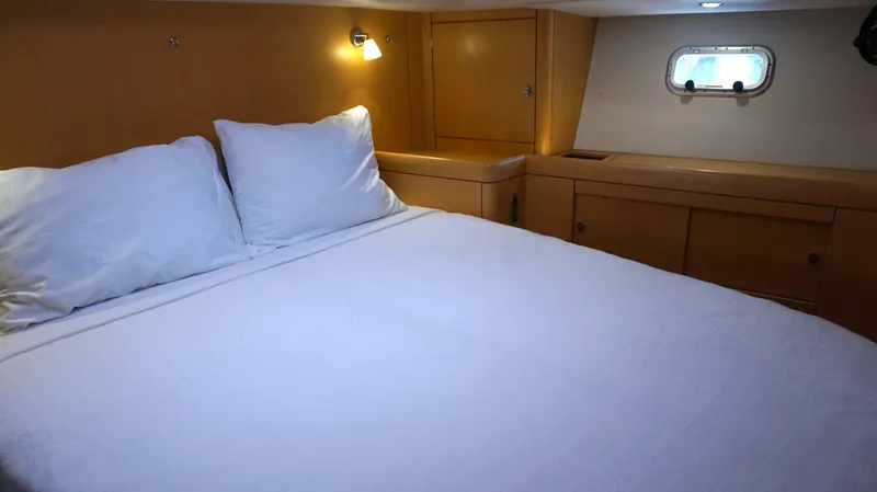 Slide: The Image of Cozy bedroom interior of 2008 Oyster 46 yacht with wooden cabinetry and soft lighting. - 42