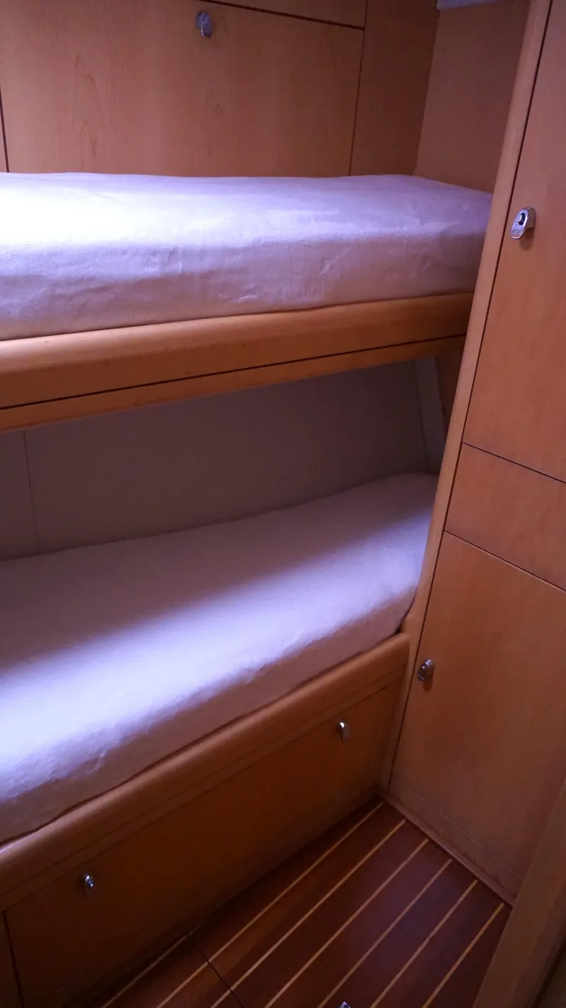 Slide: The Image of Bunk beds in 2008 Oyster 46 yacht cabin with wooden interior. - 44