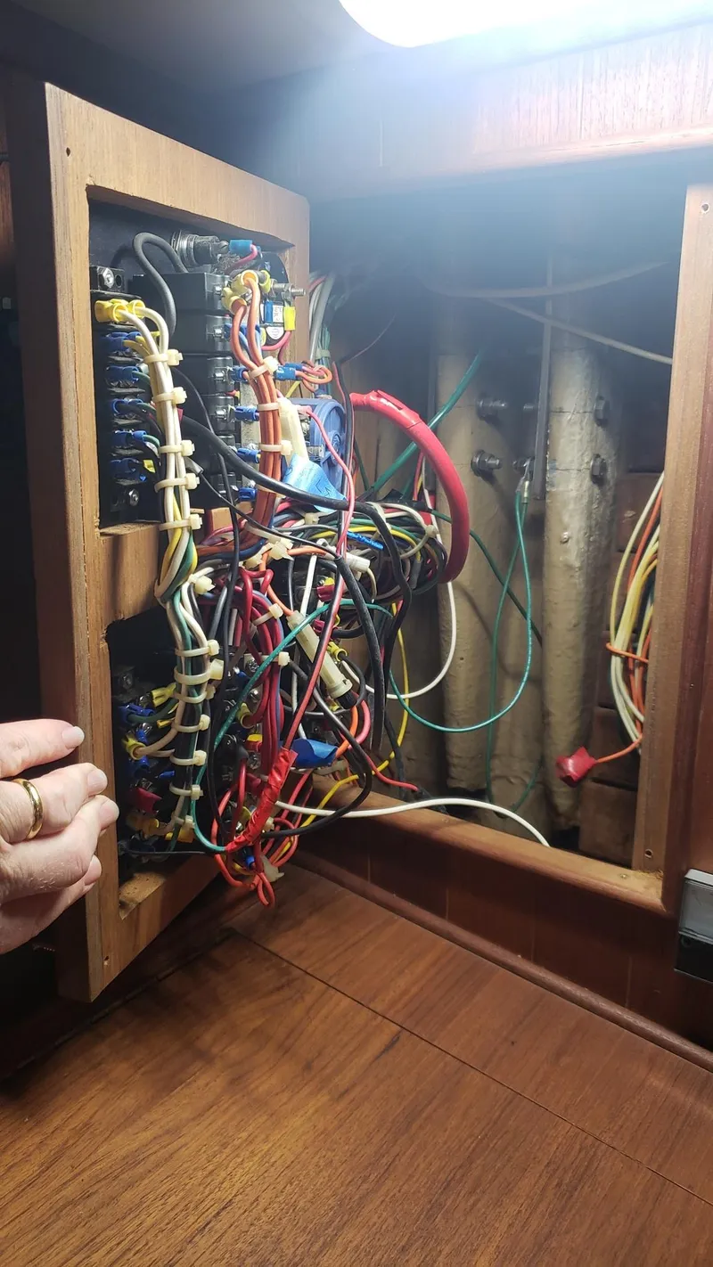 Slide: The Image of Electrical panel with complex wiring inside a 1981 Shannon 28 boat. - 17