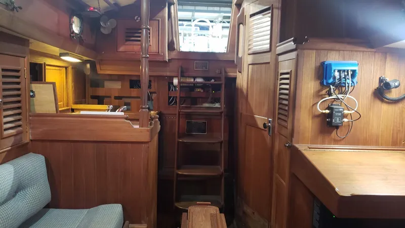 Slide: The Image of Interior of a 1981 Shannon 28 sailboat with wooden cabinetry and seating. - 18