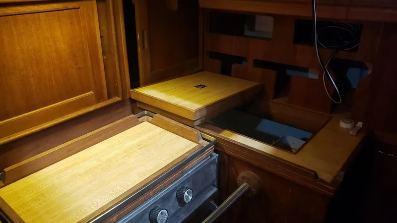 Slide: The Image of Wooden interior of a 1981 Shannon 28 boat, featuring a compact kitchen area. - 25