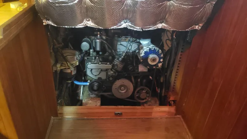 Slide: The Image of Engine compartment of a 1981 Shannon 28 boat, showcasing mechanical components and insulation. - 27