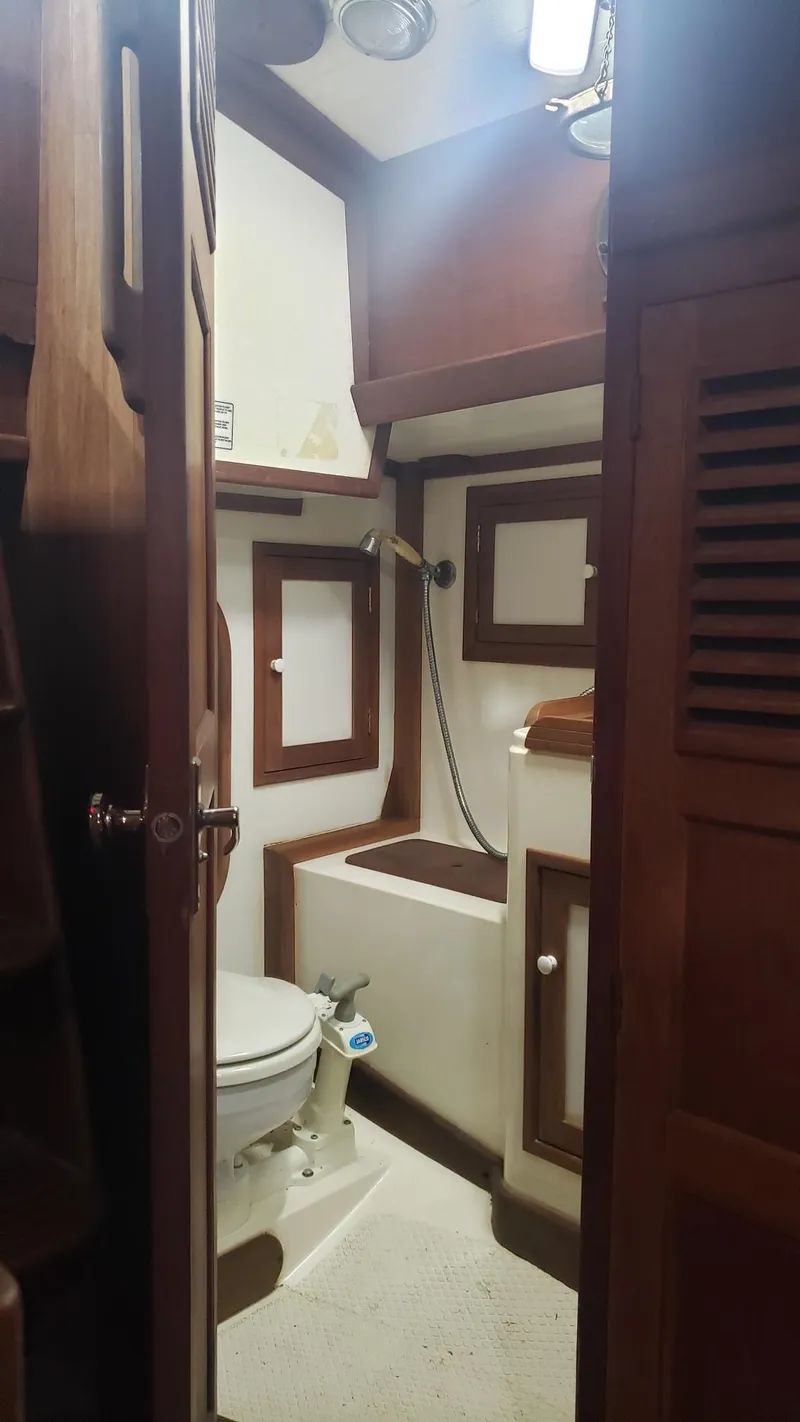 Slide: The Image of 1981 Shannon 28 sailboat bathroom with wooden accents and compact design. - 31