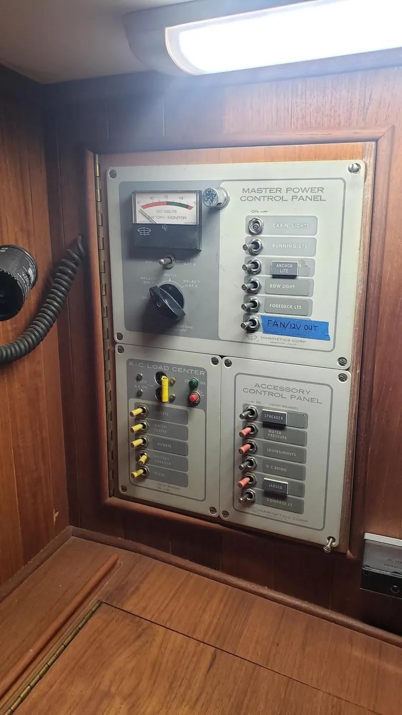 Slide: The Image of Electrical control panel on a 1981 Shannon 28 boat, featuring switches and a gauge. - 42