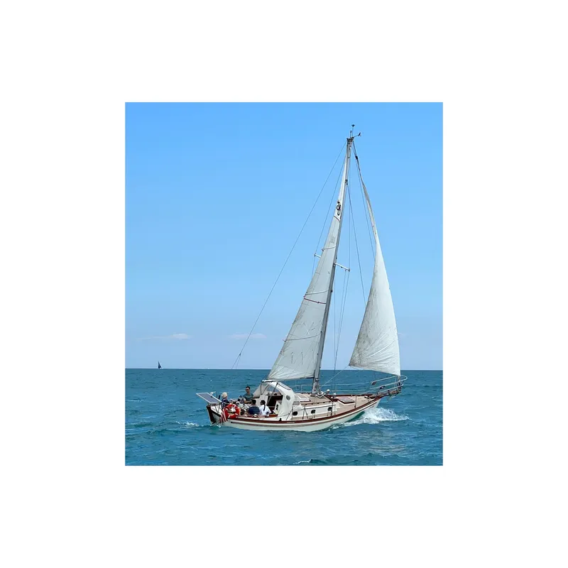 Slide: The Image of Sailing yacht Shannon 28, 1981 model, cruising on open sea under clear blue sky. - 5