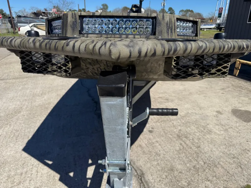 The Image of 2025 SeaArk Mud Runner 180 boat trailer with camouflage design and LED lights. - 1