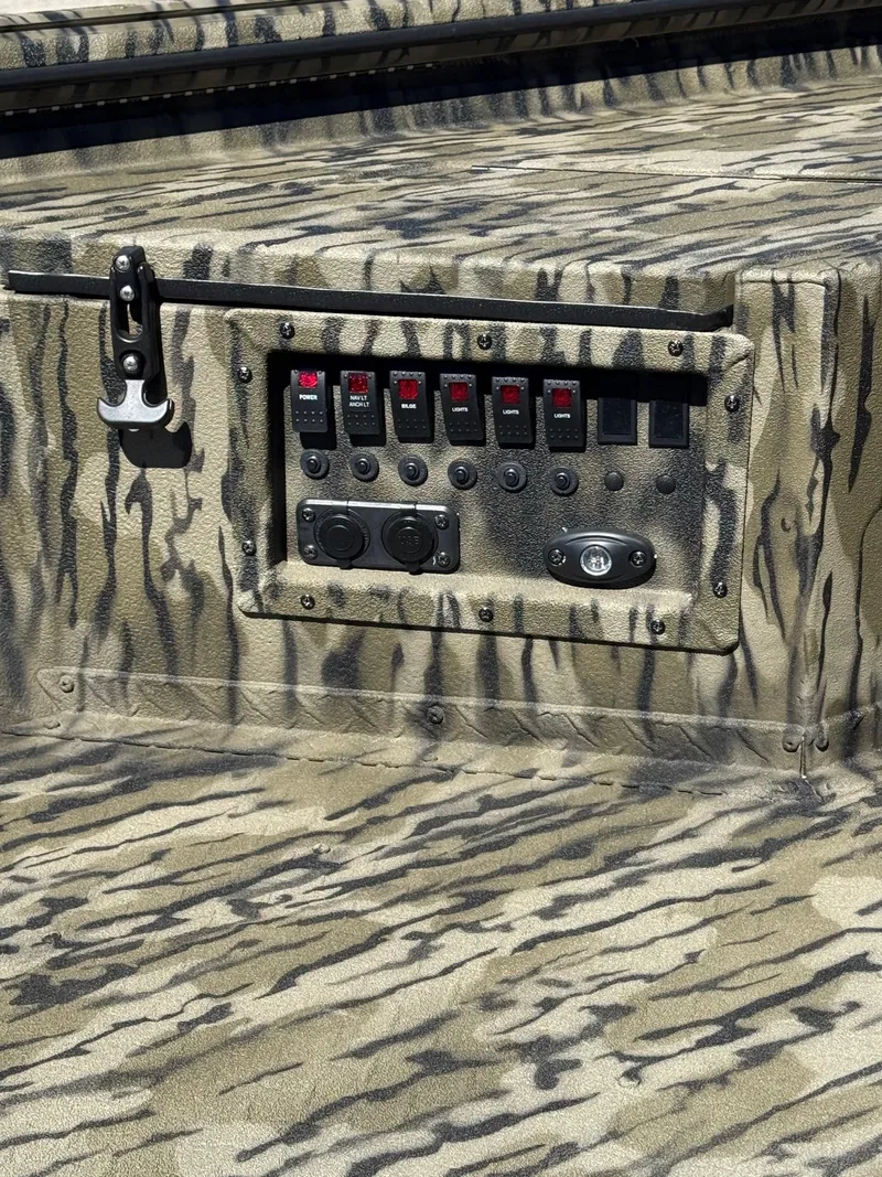 Slide: The Image of Control panel on 2025 SeaArk Mud Runner 180 with camouflage design. - 10