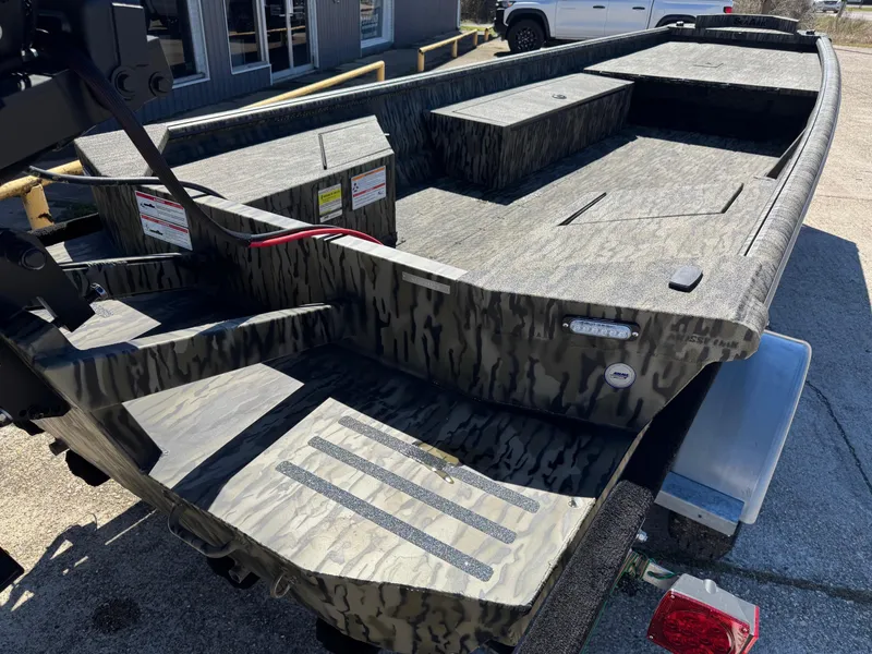 Slide: The Image of 2025 SeaArk Mud Runner 180 boat with camouflage design on a trailer. - 6