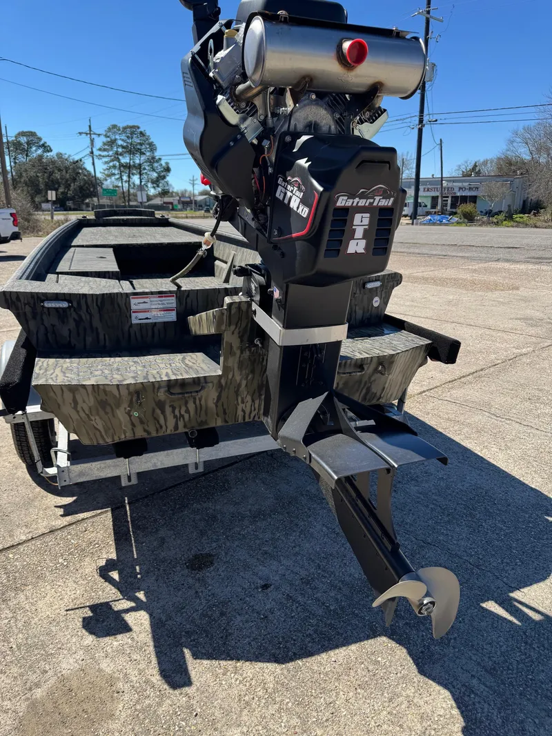 Slide: The Image of 2025 SeaArk Mud Runner 180 boat with powerful motor, parked on concrete surface. - 7