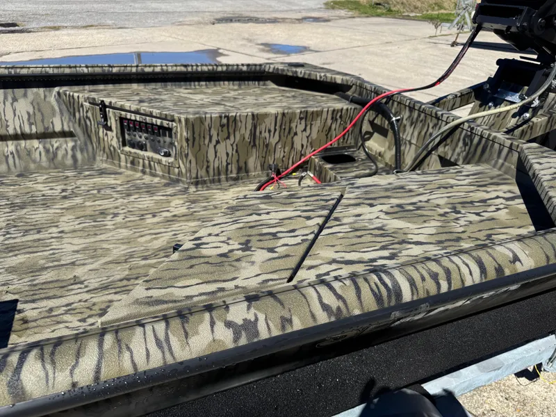 Slide: The Image of 2025 SeaArk Mud Runner 180 boat interior with camouflage design and wiring details. - 8