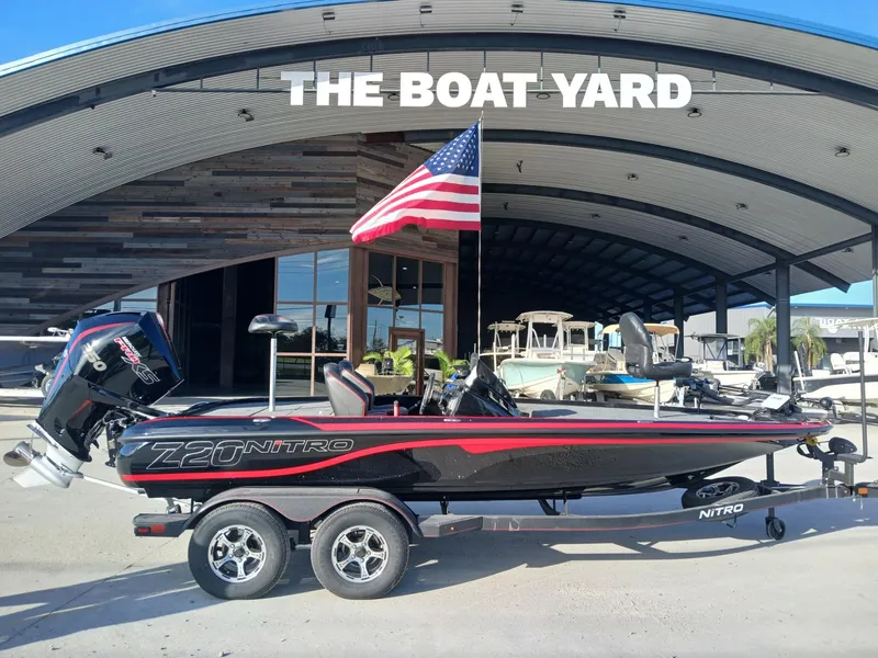 Slide: The Image of 2024 Nitro Z20 boat at The Boat Yard with American flag. - 11