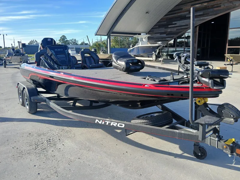Slide: The Image of 2024 Nitro Z20 boat on trailer, sleek design, parked outdoors. - 14