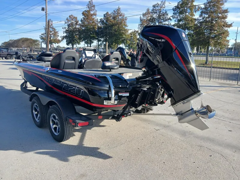 Slide: The Image of 2024 Nitro Z20 boat with powerful outboard motor, parked on a trailer in a sunny outdoor setting. - 15