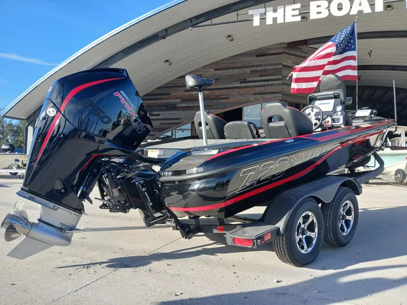 Slide: The Image of 2024 Nitro Z20 boat with American flag, parked outside a showroom. - 3