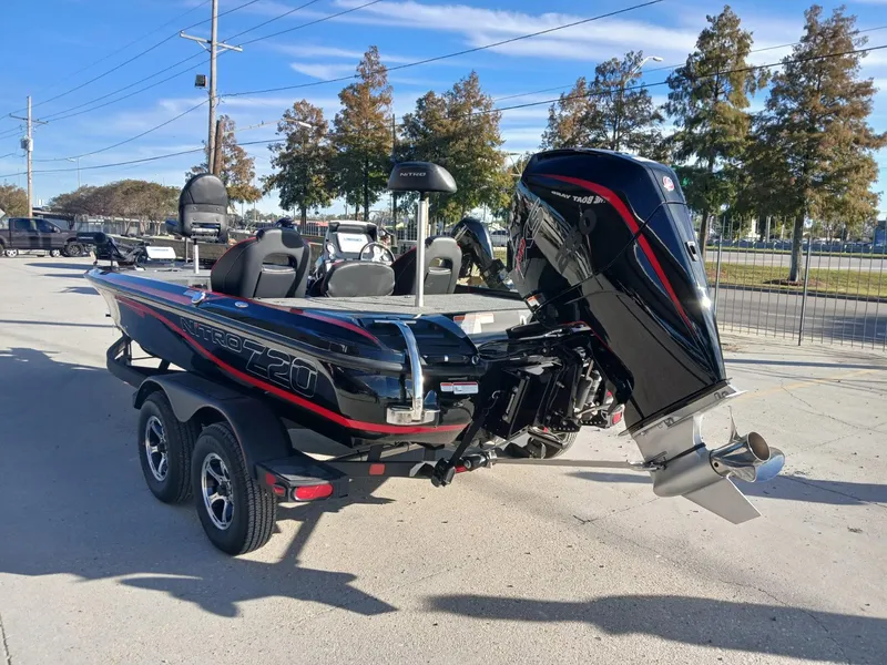 Slide: The Image of 2024 Nitro Z20 boat with powerful outboard motor, parked on a trailer. - 9