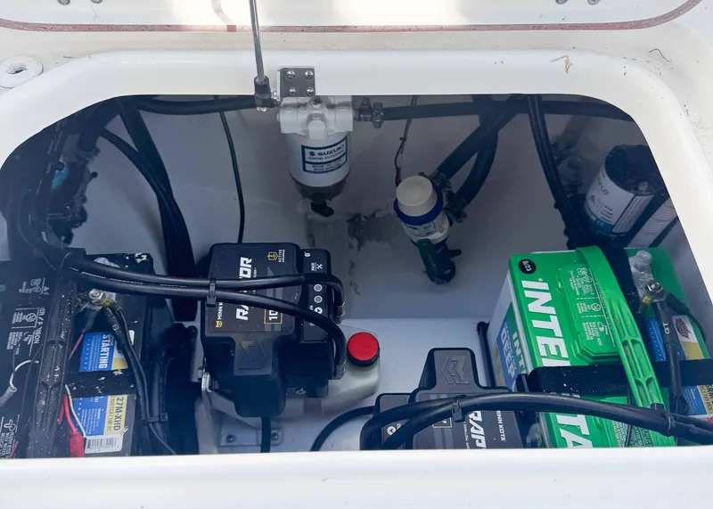 Slide: The Image of 2023 Sea Pro 240 DC boat battery compartment with wiring and components. - 11