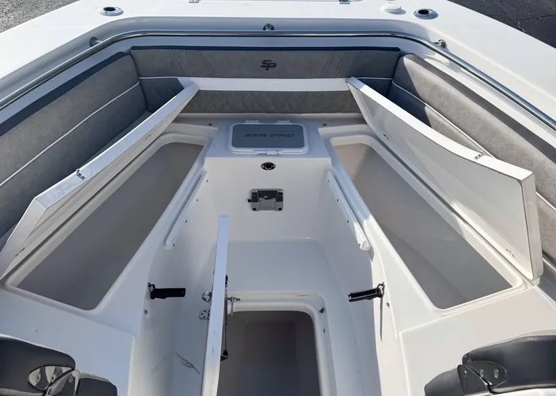 Slide: The Image of 2023 Sea Pro 240 DC boat interior with open storage compartments. - 16