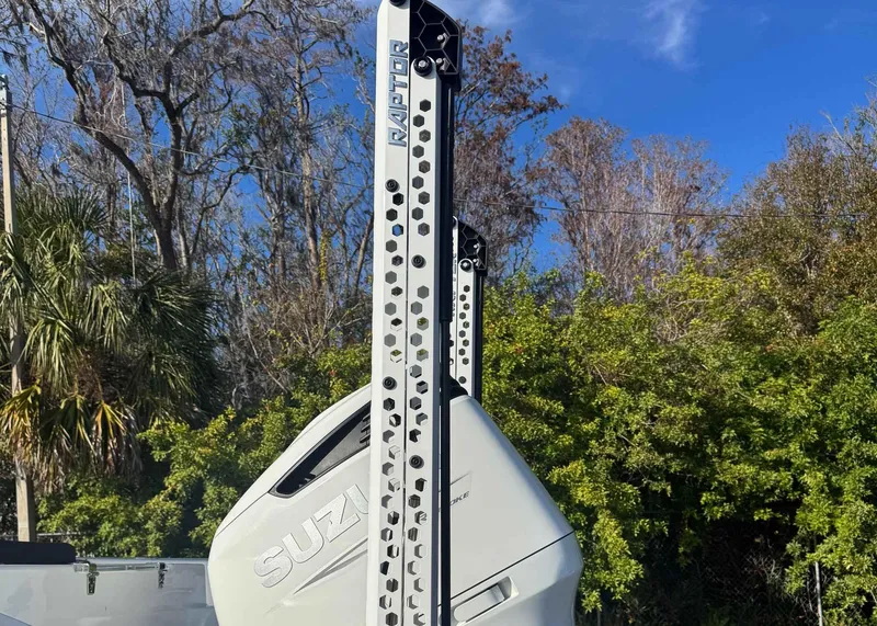 Slide: The Image of 2023 Sea Pro 240 DC boat with Suzuki engine and Raptor mount, surrounded by trees. - 4