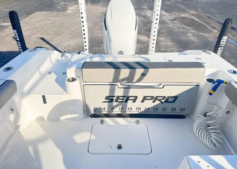 Slide: The Image of 2023 Sea Pro 240 DC boat interior with measuring board and storage compartments. - 6