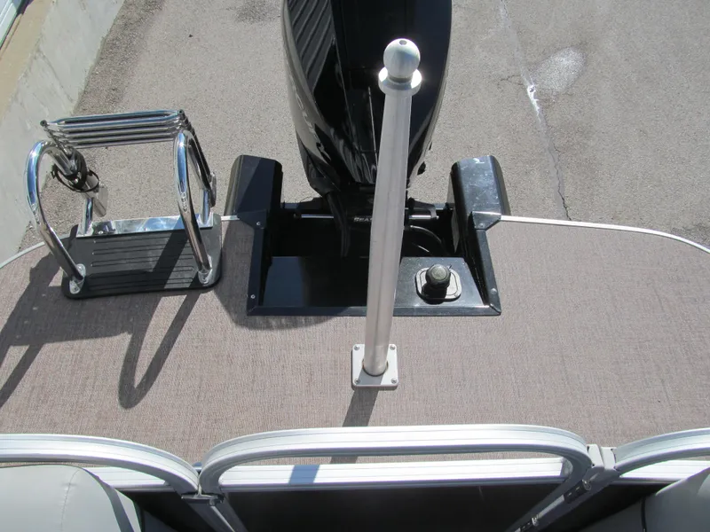 Slide: The Image of 2019 Ranger Reata 243C pontoon boat with spacious seating and canopy in showroom. - 11