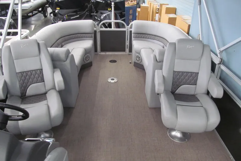 Slide: The Image of 2019 Ranger Reata 243C boat interior with plush gray seating and spacious layout. - 18