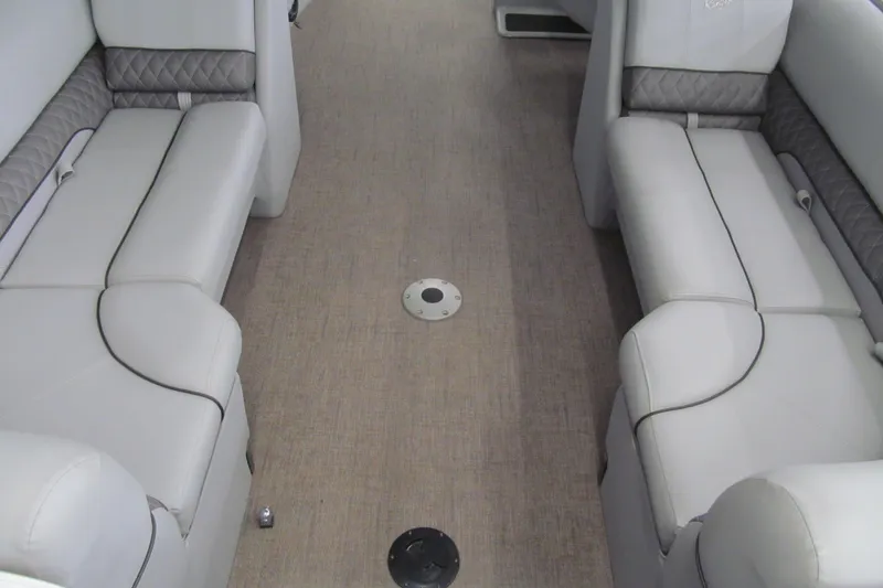 Slide: The Image of 2019 Ranger Reata 243C boat interior with gray seating and carpeted floor. - 20