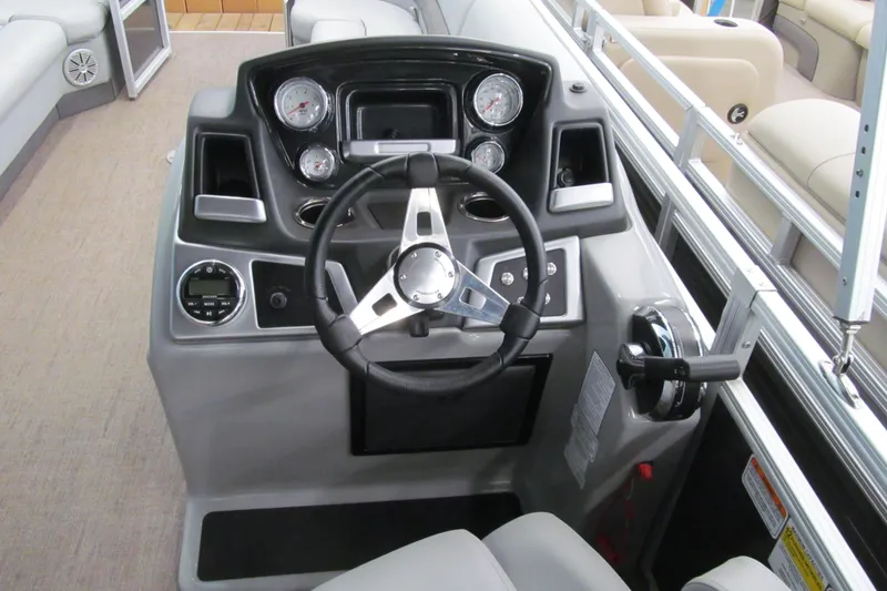 Slide: The Image of 2019 Ranger Reata 243C boat dashboard with steering wheel and gauges. - 22