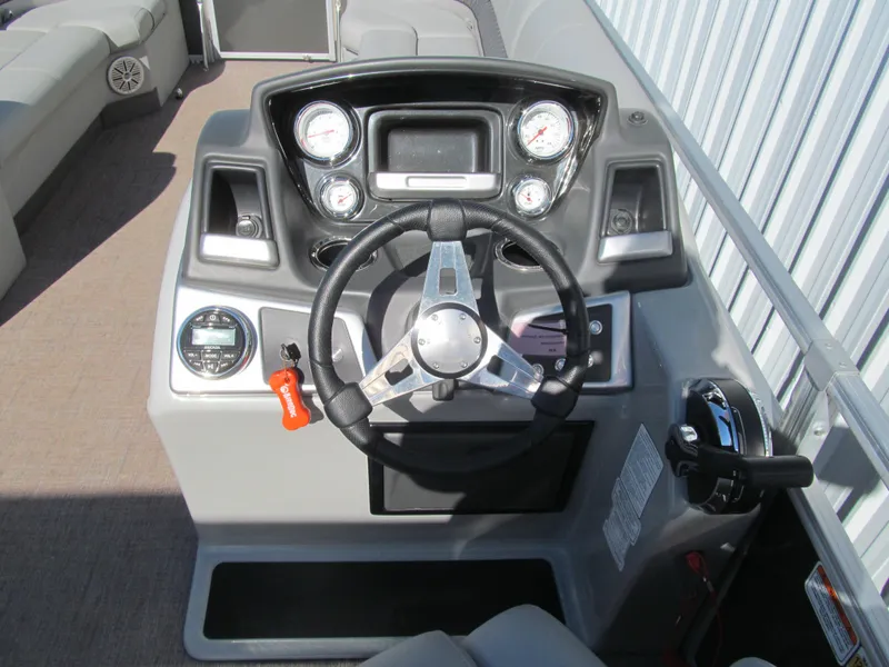 Slide: The Image of 2019 Ranger Reata 243C boat helm with steering wheel and gauges. - 6