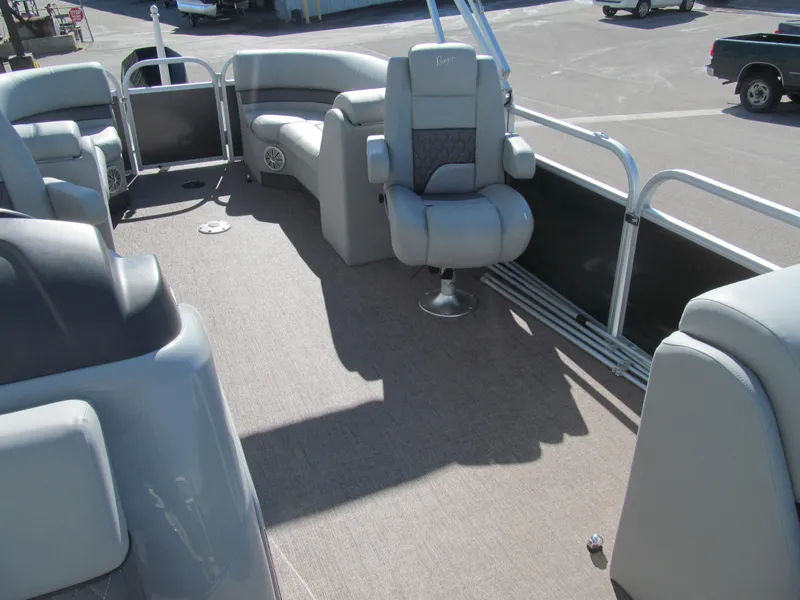Slide: The Image of 2019 Ranger Reata 243C pontoon boat interior with steering console and seating. - 9