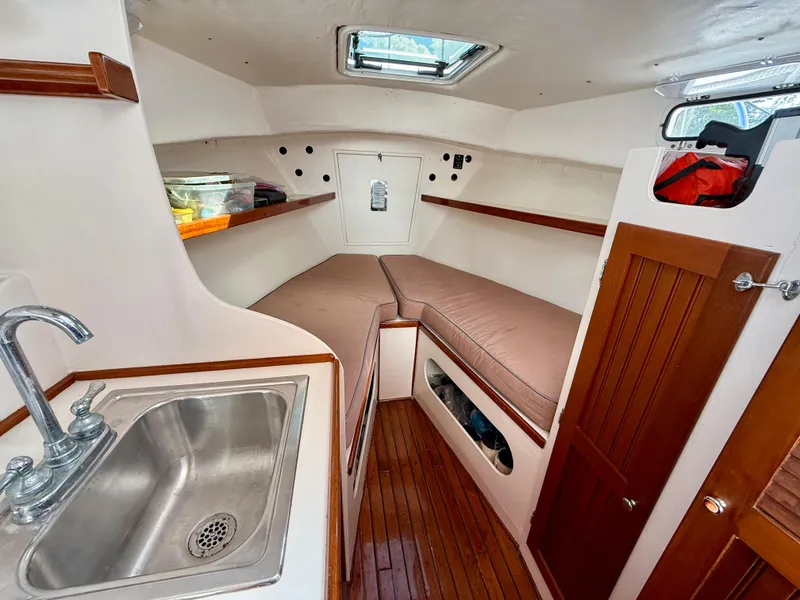 Slide: The Image of 1978 Dyer 29 Trunk Cabin interior with twin berths and wooden flooring. - 15