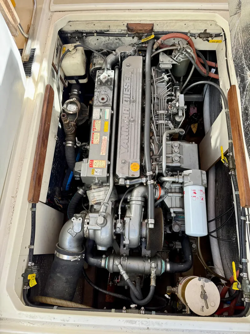 Slide: The Image of Engine compartment of a 1978 Dyer 29 Trunk Cabin boat, showcasing detailed mechanical components. - 29