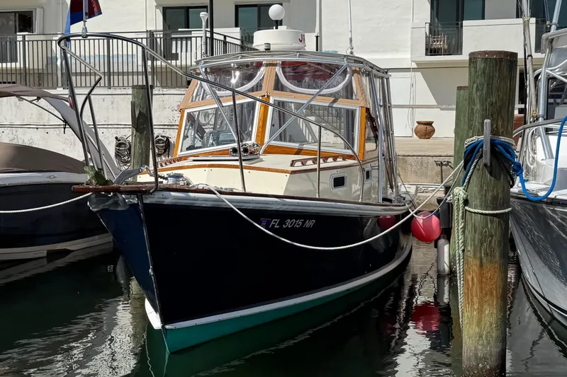 Slide: The Image of 1978 Dyer 29 Trunk Cabin boat docked at marina, surrounded by other vessels. - 4