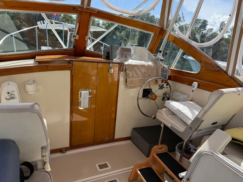 Slide: The Image of 1978 Dyer 29 Trunk Cabin boat named "Thistle" docked at a marina. - 8
