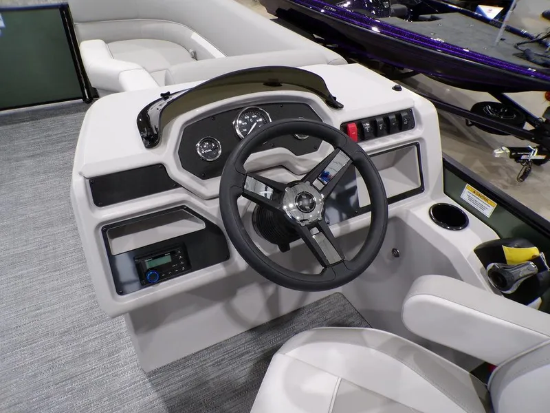 Slide: The Image of 2025 Godfrey Xperience 2286 SFLX boat dashboard with steering wheel and controls. - 11