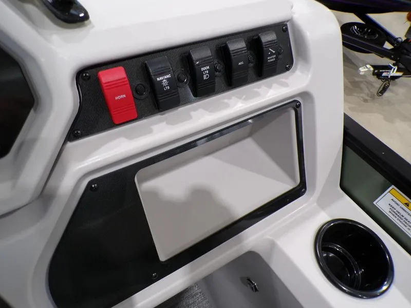 Slide: The Image of Control panel of 2025 Godfrey Xperience 2286 SFLX boat with switches and cup holder. - 27