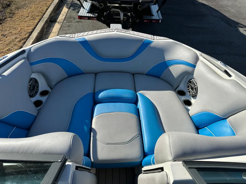 Slide: The Image of 2022 MB B52 23 Alpha boat interior with blue and gray seating and built-in speakers. - 6