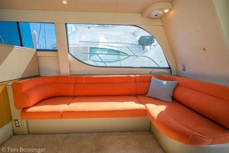 Slide: The Image of Interior of 2001 Bayliner 3788 yacht with orange seating and large window. - 11