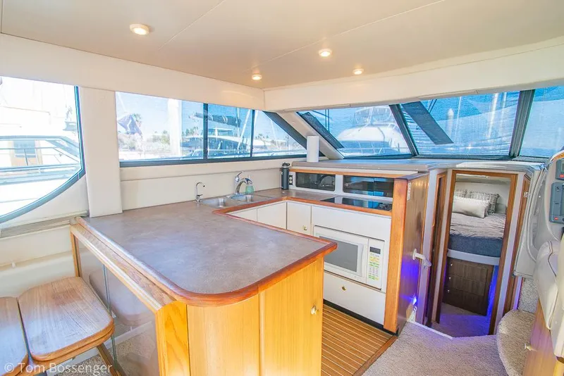 Slide: The Image of Interior of 2001 Bayliner 3788 Command Bridge Motoryacht with kitchen and seating area. - 12