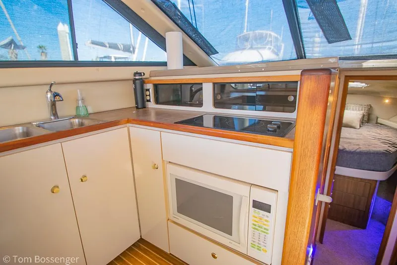 Slide: The Image of 2001 Bayliner 3788 Command Bridge Motoryacht kitchen with microwave and stove. - 14