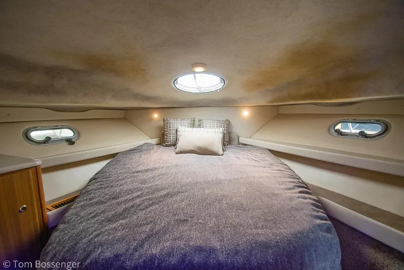 Slide: The Image of 2001 Bayliner 3788 Command Bridge Motoryacht cabin with cozy bed and porthole windows. - 19