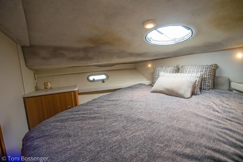 Slide: The Image of 2001 Bayliner 3788 Command Bridge Motoryacht cabin with bed, porthole, and ambient lighting. - 20