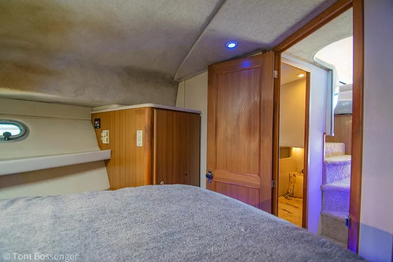 Slide: The Image of Interior cabin of 2001 Bayliner 3788 Command Bridge Motoryacht with wooden door and cozy bed. - 22