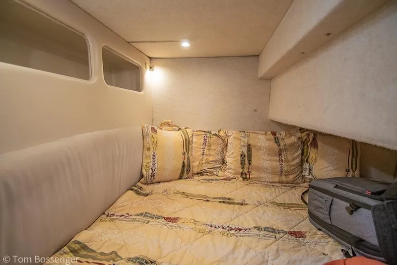 Slide: The Image of Cozy cabin interior of 2001 Bayliner 3788 Command Bridge Motoryacht with patterned bedding. - 24