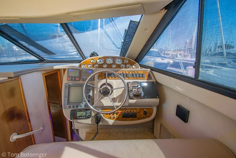 Slide: The Image of 2001 Bayliner 3788 Command Bridge Motoryacht helm with steering wheel and navigation instruments. - 28