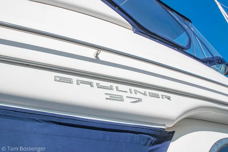 Slide: The Image of 2001 Bayliner 3788 Command Bridge Motoryacht side view with logo detail. - 3