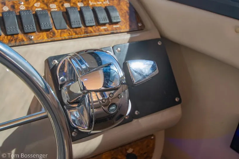 Slide: The Image of Control panel of 2001 Bayliner 3788 Command Bridge Motoryacht with steering wheel and switches. - 32