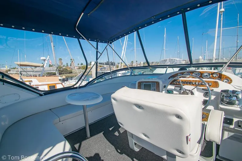 Slide: The Image of 2001 Bayliner 3788 Command Bridge Motoryacht cockpit with helm, seating, and marina view. - 38