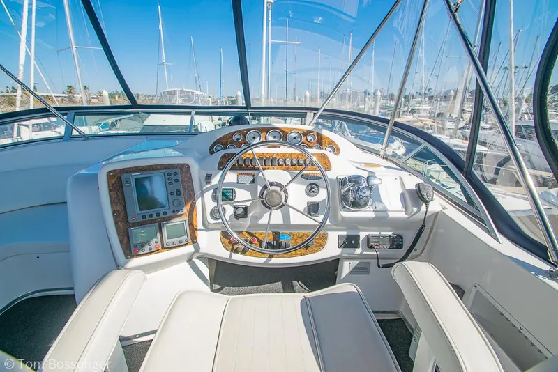 Slide: The Image of 2001 Bayliner 3788 Command Bridge Motoryacht helm with navigation instruments and steering wheel. - 40