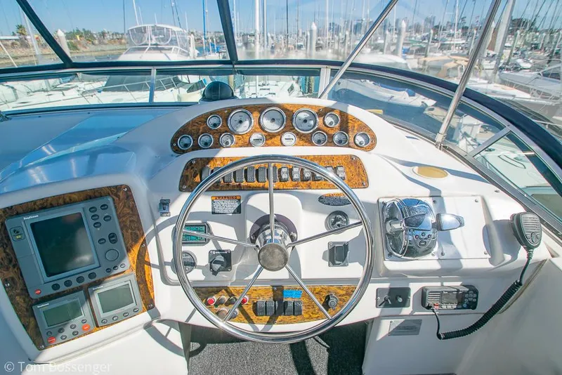 Slide: The Image of 2001 Bayliner 3788 Command Bridge Motoryacht helm with gauges, steering wheel, and navigation equipment. - 44
